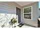 Welcoming front entrance features gray door, charming welcome mat, stylish potted plant, and great natural light at 1229 Kohler Ave, Charlotte, NC 28206