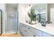 Double vanity bathroom with white cabinets, quartz countertops and large shower at 6308 Honor Ave, Midland, NC 28107