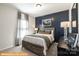 Bedroom with dark blue accent wall, and full-size bed at 6308 Honor Ave, Midland, NC 28107