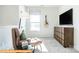 Bonus room with comfy chair, large TV and guitar on the wall at 6308 Honor Ave, Midland, NC 28107