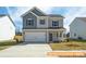 Two-story house with gray and white siding, two-car garage, and landscaped yard at 6308 Honor Ave, Midland, NC 28107