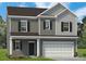 Two story house, gray siding, white garage door, and small front yard at 6308 Honor Ave, Midland, NC 28107