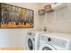 Bright laundry room, washer and dryer included, with shelving and stylish wall art at 6308 Honor Ave, Midland, NC 28107