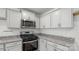 Corner kitchen with granite countertops and stainless steel appliances at 1411 5Th Street Ne Dr, Hickory, NC 28601