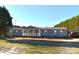 Ranch home with stone exterior, red metal roof, and covered porch at 1590 George Brown Rd, Crouse, NC 28033