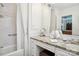 White tiled bathroom with granite countertop, shower, and bathtub at 1723 Maryland Ave, Charlotte, NC 28209