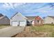 Brick and vinyl ranch home with two-car garage and landscaped lawn at 1953 Stonewyck Ave, Kannapolis, NC 28081