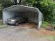 Open carport with a gray pickup truck parked inside, offering convenient vehicle storage at 212 W Bingham St, Statesville, NC 28677