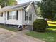 Charming home featuring well-maintained landscaping, steps, and a sidewalk leading to the front door at 212 W Bingham St, Statesville, NC 28677