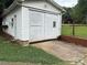 Exterior view of garage with a large door and small boarded up windows on the side of the house at 212 W Bingham St, Statesville, NC 28677