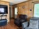 Comfortable living room features warm wood paneling, TV, and comfortable seating at 212 W Bingham St, Statesville, NC 28677