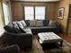 Relaxing living room area with a large sectional sofa and bright natural light at 212 W Bingham St, Statesville, NC 28677