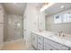 Bright bathroom offers double sink vanity and glass shower enclosure at 225 Davidson Gateway Dr, Davidson, NC 28036