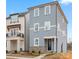 Charming two-story home with blue siding, brick accents, and well-manicured landscaping at 225 Davidson Gateway Dr, Davidson, NC 28036