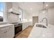 A modern kitchen with stainless steel appliances, white cabinets, and marble countertops at 225 Davidson Gateway Dr, Davidson, NC 28036