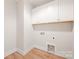 A functional laundry room with ample storage space above at 225 Davidson Gateway Dr, Davidson, NC 28036