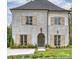 Two-story house with gray brick, taupe shutters, and a landscaped lawn at 238 Laurel S Ave # A, Charlotte, NC 28207