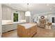 Modern kitchen with light gray cabinets, marble island, and stainless steel appliances at 238 Laurel S Ave # A, Charlotte, NC 28207