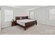 Bright bedroom with a wooden sleigh bed and ample space at 310 Hyssop Ct, Fort Mill, SC 29715