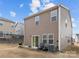 Rear view of house, with patio, two chairs, and grill at 310 Hyssop Ct, Fort Mill, SC 29715