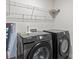Modern laundry room with Samsung washer and dryer, and overhead shelving at 310 Hyssop Ct, Fort Mill, SC 29715
