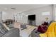 Open concept living area with gray sectional and wood floors at 310 Hyssop Ct, Fort Mill, SC 29715