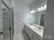 Elegant bathroom with dual vanity, a large mirror, modern fixtures, and a glass-enclosed shower at 3103 Beacon Heights Rd, Indian Land, SC 29707