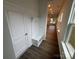 Inviting entryway with a coat rack, bench, and hardwood floors, leading into a naturally lit hallway at 3103 Beacon Heights Rd, Indian Land, SC 29707