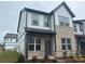 Charming two-story home featuring a brick facade, light gray siding, and professionally landscaped front yard at 3103 Beacon Heights Rd, Indian Land, SC 29707