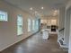 Open-concept living space with large windows and hardwood floors offering lots of natural lighting at 3103 Beacon Heights Rd, Indian Land, SC 29707