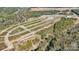 Development showcasing home sites next to completed townhomes surrounded by a dense canopy of trees at 3107 Beacon Heights Rd, Indian Land, SC 29707