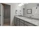 Bright bathroom featuring double sinks, granite countertops, and a full-size mirror at 3107 Beacon Heights Rd, Indian Land, SC 29707