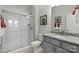 Bathroom features a gray vanity with granite countertop, framed mirror, and shower with glass doors at 3107 Beacon Heights Rd, Indian Land, SC 29707