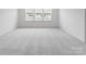 Bright, carpeted bedroom featuring three windows for ample natural light at 3107 Beacon Heights Rd, Indian Land, SC 29707