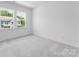 A well-lit, carpeted bedroom featuring two large windows at 3107 Beacon Heights Rd, Indian Land, SC 29707