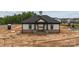 A clubhouse exterior with stone accents and an inviting entrance, complemented by the surrounding construction site at 3107 Beacon Heights Rd, Indian Land, SC 29707