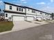 Row of modern townhomes featuring attached garages and neat landscaping at 3107 Beacon Heights Rd, Indian Land, SC 29707