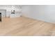 Open-concept living space with kitchen view and hardwood floors at 3107 Beacon Heights Rd, Indian Land, SC 29707