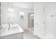 Bright bathroom with double sink vanity, large mirror and walk-in shower with glass door at 3109 Beacon Heights Rd, Indian Land, SC 29707