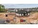 Completed community cabana structure with black roof, white walls and stone accents; construction in the background at 3109 Beacon Heights Rd, Indian Land, SC 29707
