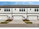 View of new construction townhomes with garages, neutral paint, and manicured lawns at 3109 Beacon Heights Rd, Indian Land, SC 29707