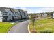 Street view of newly built modern townhomes, featuring sidewalks and manicured lawns at 3109 Beacon Heights Rd, Indian Land, SC 29707