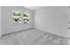 Bright bedroom featuring plush carpeting and large windows showcasing neighborhood views at 3111 Beacon Heights Rd, Indian Land, SC 29707