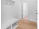 Hallway with a bench and coat hooks and a light, wood floor at 3111 Beacon Heights Rd, Indian Land, SC 29707