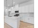 Bright kitchen featuring quartz countertops, stainless steel appliances, and stylish pendant lighting at 3111 Beacon Heights Rd, Indian Land, SC 29707