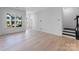 Open concept living space with hardwood floors, large windows, and ample natural light at 3111 Beacon Heights Rd, Indian Land, SC 29707