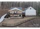 Lakefront property showcasing house, detached garage, and expansive yard at 42610 Moonshine Dr, New London, NC 28127