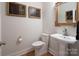 Simple bathroom with pedestal sink and hardwood floor at 42610 Moonshine Dr, New London, NC 28127