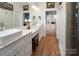 Elegant bathroom with double vanity, large mirror, and separate shower at 42610 Moonshine Dr, New London, NC 28127