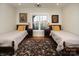 Two twin beds in a well-lit bedroom, featuring a lovely view from the window at 42610 Moonshine Dr, New London, NC 28127